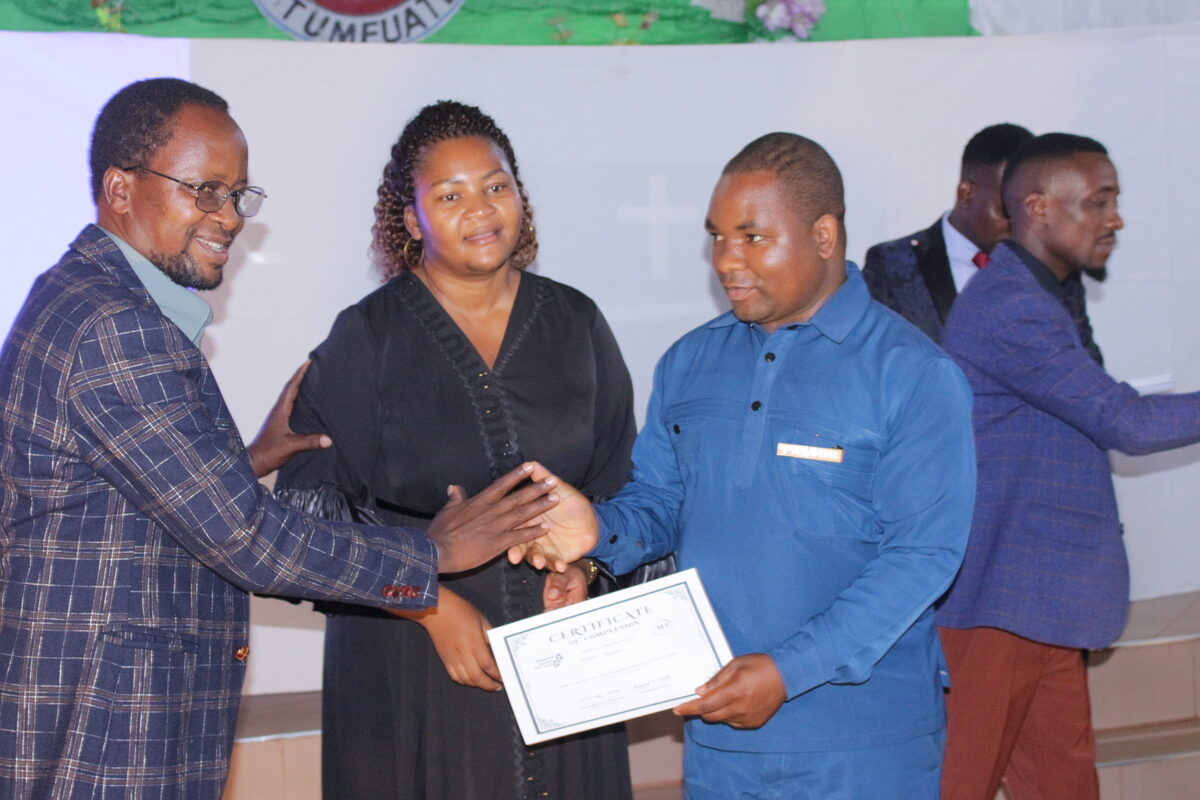 Certificate of completion being presented to a graduate